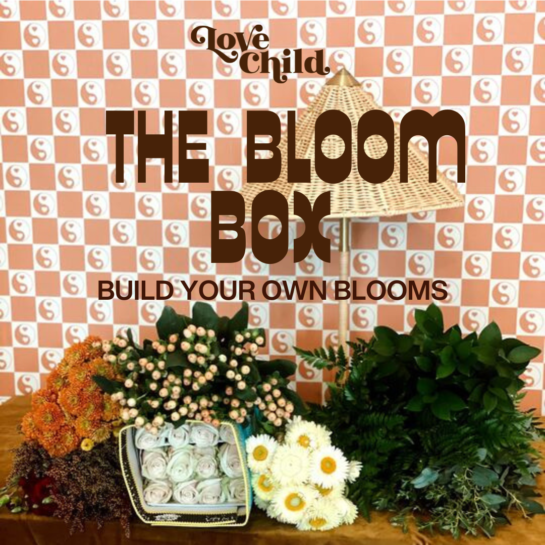 Advertisement for 'The Bloom Box' with flowers and plants on a checkered background.